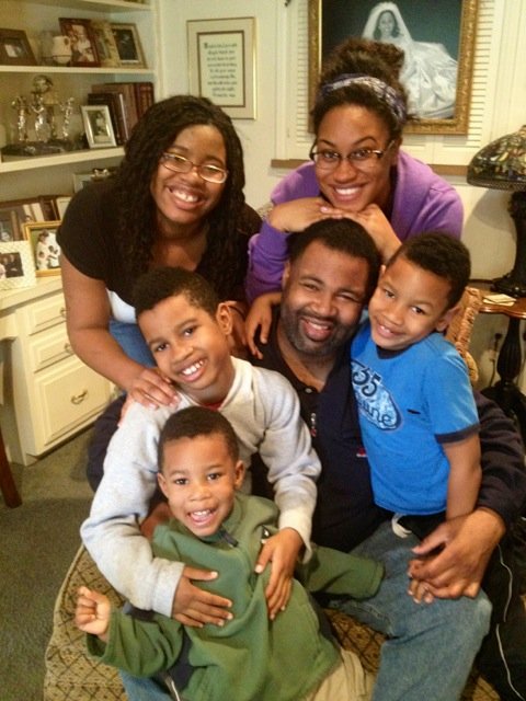 Image of Chrystal Evans Hurst with her husband, Jessie Hurst, and their kids